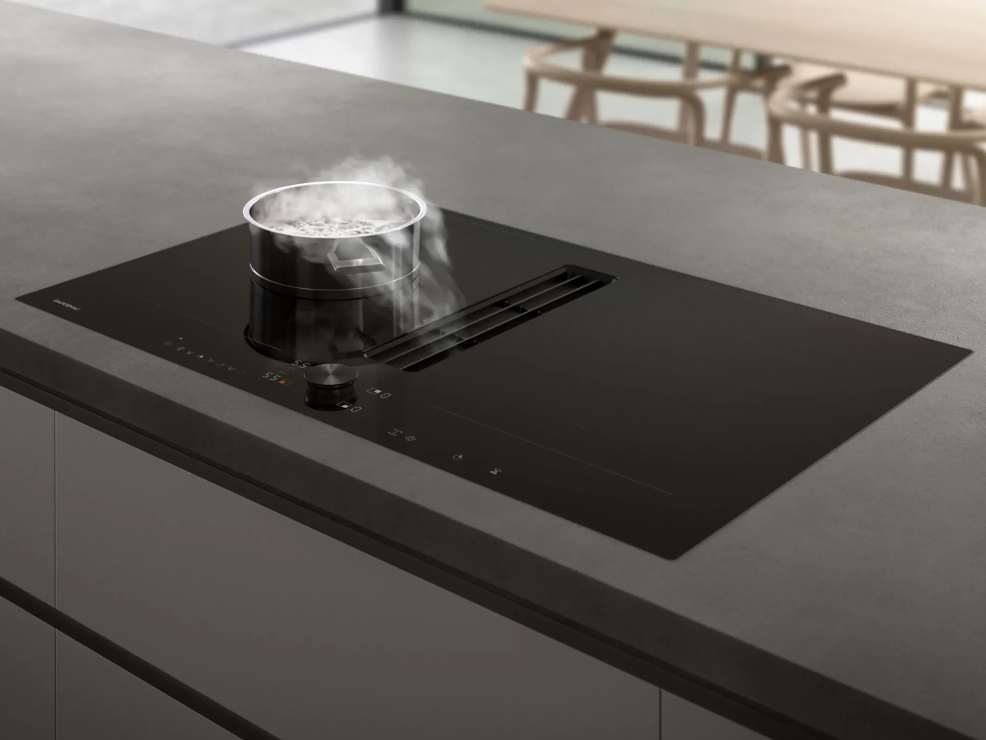 Gaggenau inductiekookplaat met geïntegreerde downdraft afzuiging op betonlook eiland